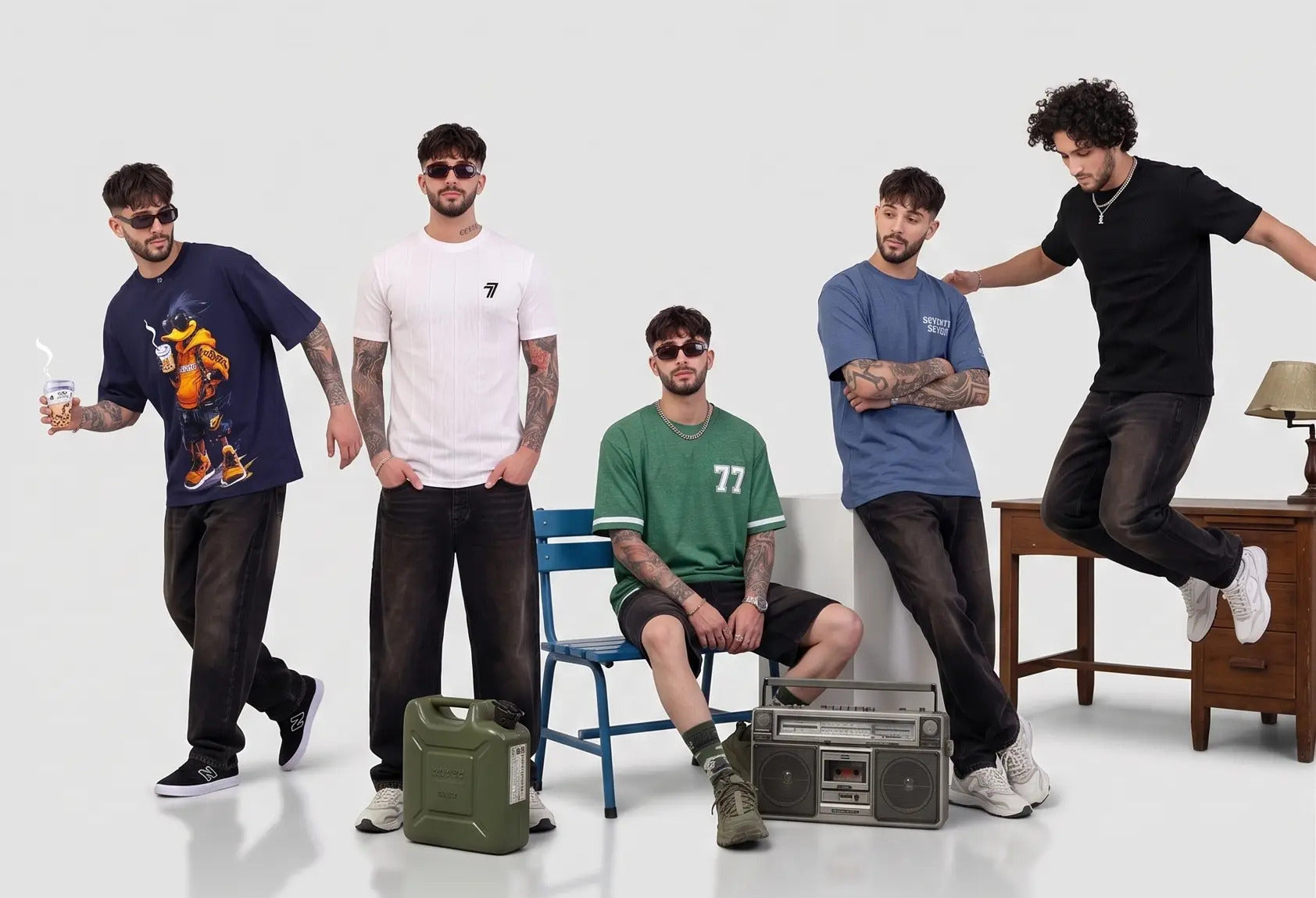 Five men posing in a casual setting with a white background
